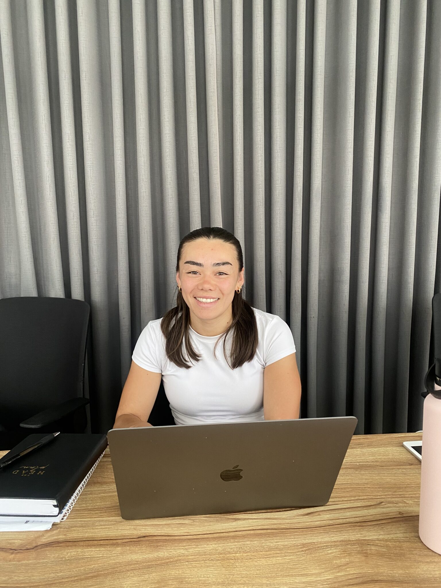 Anna working at her desk with laptop in a professional office setting